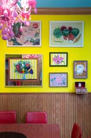 Colourful art display on yellow wall