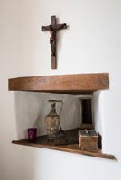 18th century carved crucifix, a Greek vase, a Bible and a 12th century pyx in alcove - Cothay Manor
