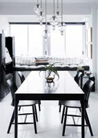 Monochrome dining room with window seat