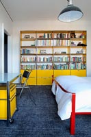 Yellow bookcase in bedroom