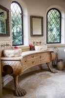 Bathroom sinks on ornate cabinet