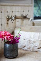 Vase of flowers beside sink