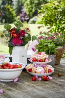 Desserts and flowers on garden table