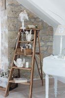 Accessories displayed on an old wooden ladder