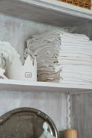 Folded napkins on wooden shelf