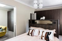 Contemporary bedroom with Italian 1960s ceiling light and porcelain lion ornament