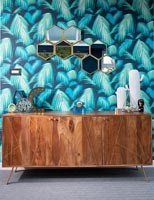 Vintage wooden sideboard against feature wall