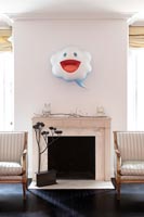 Marble fireplace with quirky wall mounted sculpture 