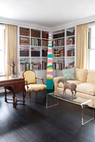 Corner bookshelves in eclectic living room 