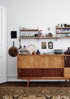 Wooden sideboard and shelving in dining room 