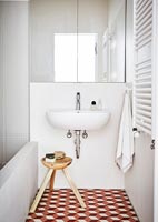 Sink in modern bathroom with wooden stool 