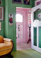 Colourfully painted walls in living room with view to hallway 