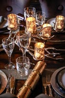 Decorative candle holders on dining table laid for Christmas dinner