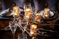 Decorative glass candle holders on dining table at Christmas