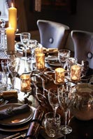 Decorative glass candle holders on dining table at Christmas