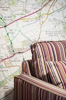Map wallpaper and striped furniture 