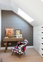 Dressing table with colourfully covered chair 