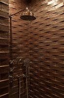 Shower with brown brick style tiling throughout 