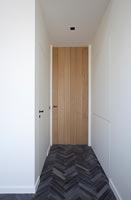 Modern corridor and door with unusual flooring  