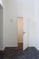 Modern corridor and open internal door with unusual flooring  