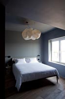 Grey bedroom with white cloud shaped lampshade 
