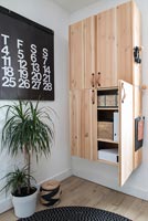 Wall mounted wooden cabinet and modern artwork calendar 