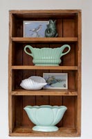 Wooden alcove shelves with display of collectibles 