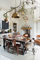 Decorated branch over dining table in modern kitchen-diner 