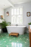Modern bathroom with bright green floor  