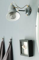 Grey wall mounted retro lamp on grey painted wall 
