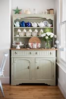 Pale green Welsh dresser in modern country dining room 