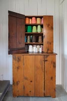 Vintage wooden cabinet filled with colourful spools of thread 