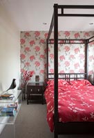 Black and red bedroom with floral feature wall 