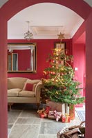 Red living room with Christmas tree