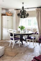 Stone floor in eclectic country dining room 
