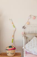 Decorative basket and painted stick in childrens room 