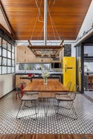 Modern industrial kitchen-diner with open sliding patio doors 