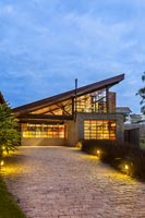 Contemporary house with pitched roof illuminated at night - Brazil 