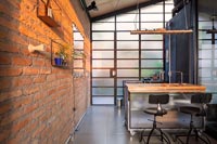 Modern industrial kitchen with exposed brick wall 
