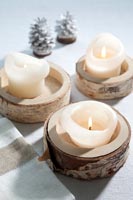 Decorative silver birch candle holders on Christmas table 
