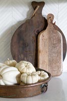 Small white pumpkins and wooden chopping boards 