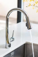 Modern kitchen faucet with running water