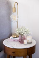Modern lamp on marble topped bedside table 