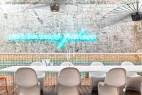 Illuminated neon artwork on contemporary dining room wall 