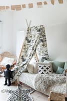 Tepee style canopy over daybed in childrens room 