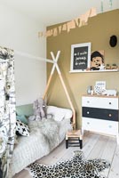 Modern childrens room with triangular bed frame for canopy 