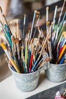 Metal pots of artist's brushes 