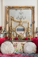 Collection of gilded mirrors on mantelpiece 