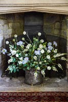 Flower arrangement in large fireplace 