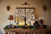 Christmas decorations on wooden sideboard 